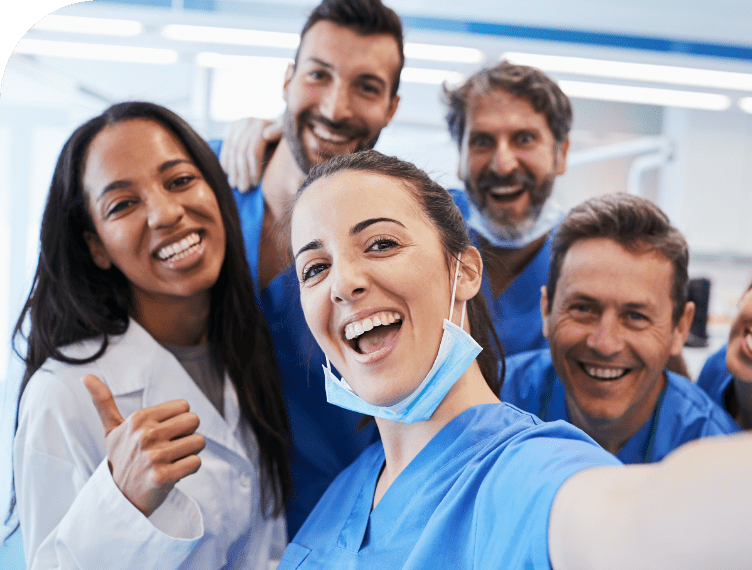Nurses smiling andtaking a picture in a group.